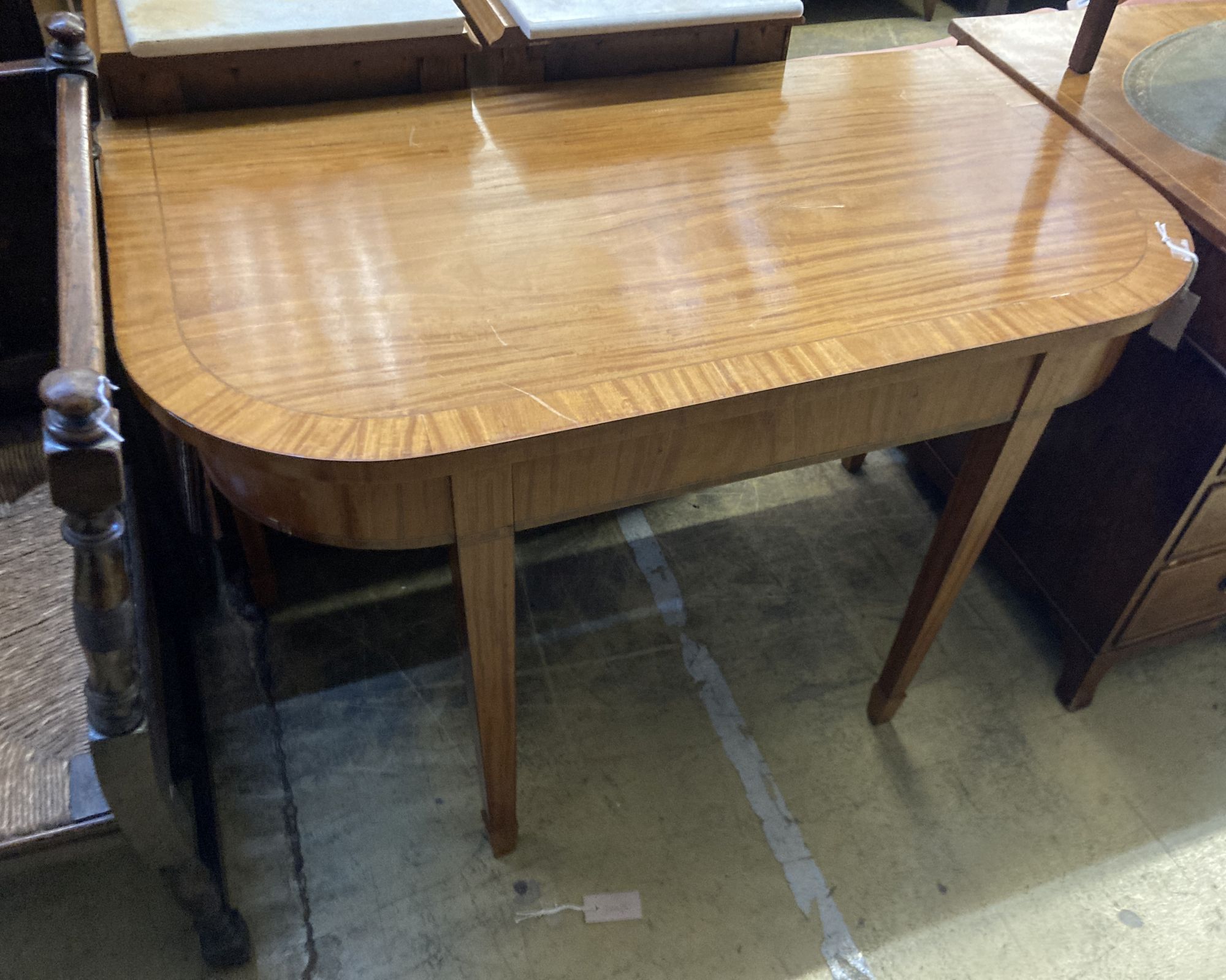 A George III Sheraton style satinwood D shaped table, fitted frieze drawer, width 106cm, depth 60cm, height 75cm